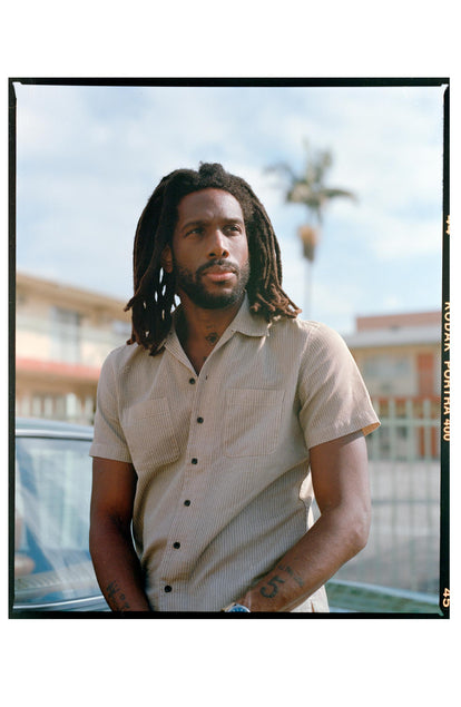 fit model posing in The Conrad Shirt in Black Coffee Stripe