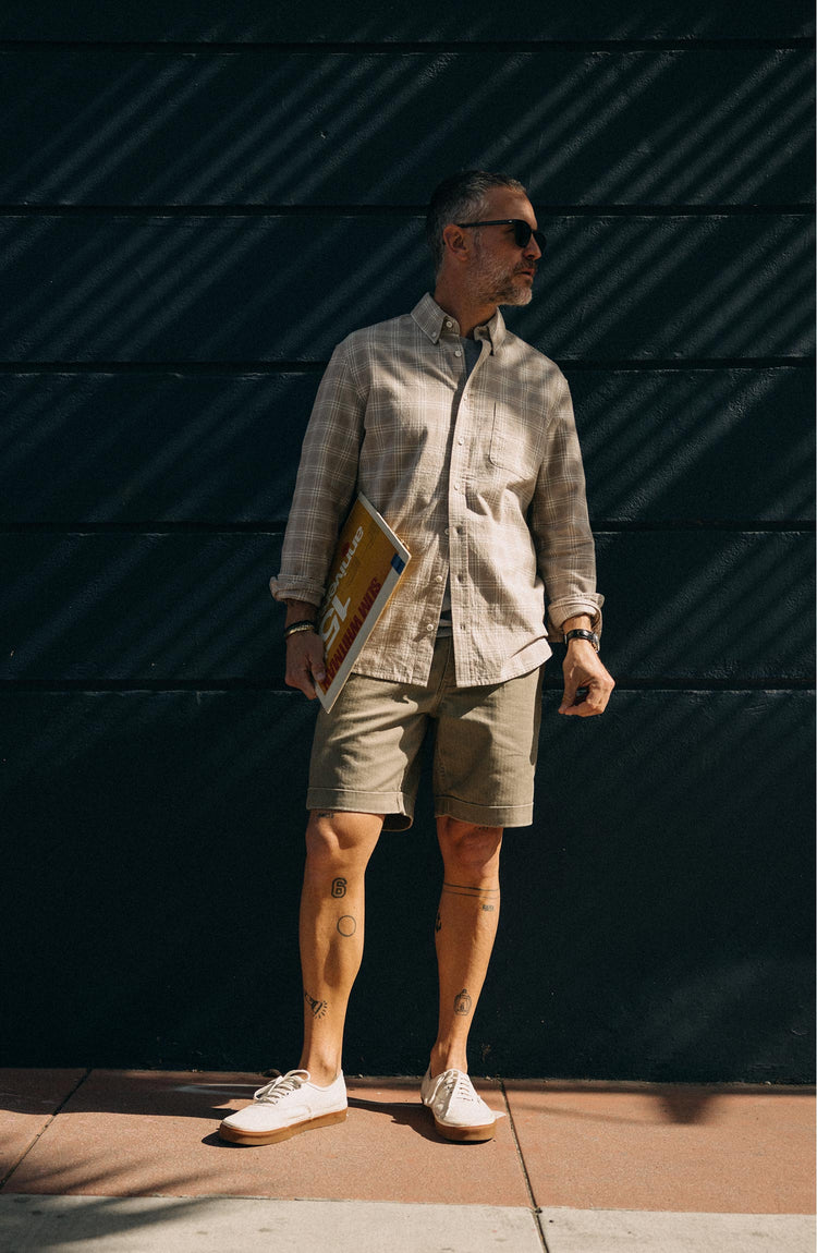 fit model leaning against the wall wearing The Jack in Heather Flax Plaid