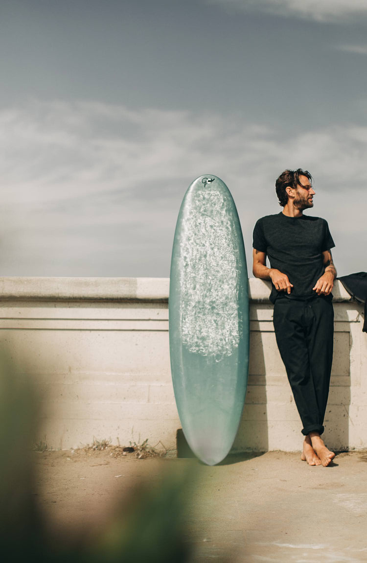 our guy rocking the merino tee near the beach—with text overlaying