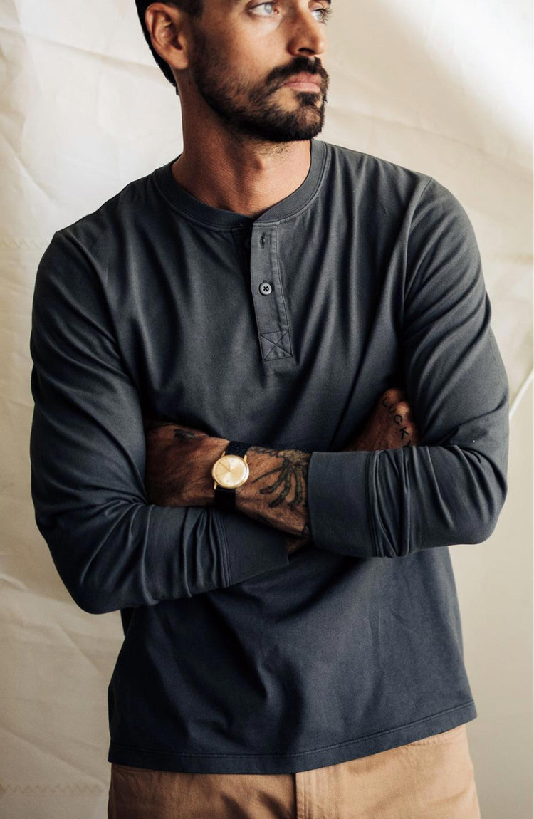 fit model with his arms crossed wearing The Organic Cotton Henley in Faded Black