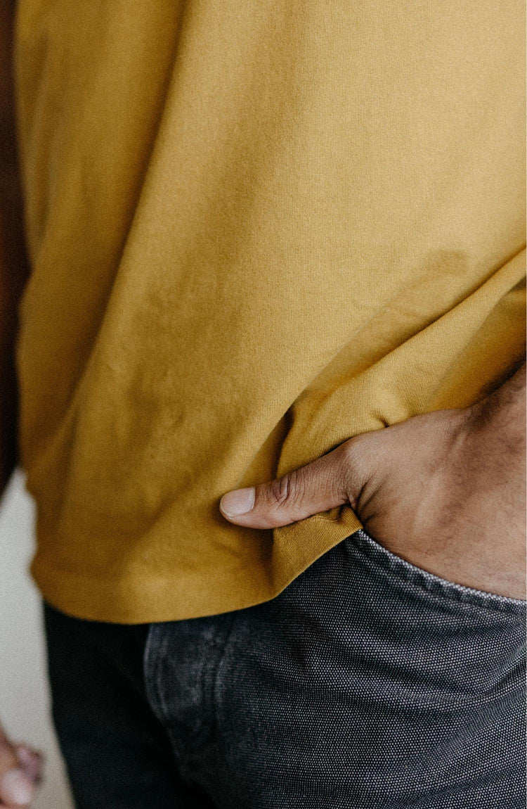 fit model showing off collar on The Organic Cotton Tee in Old Gold