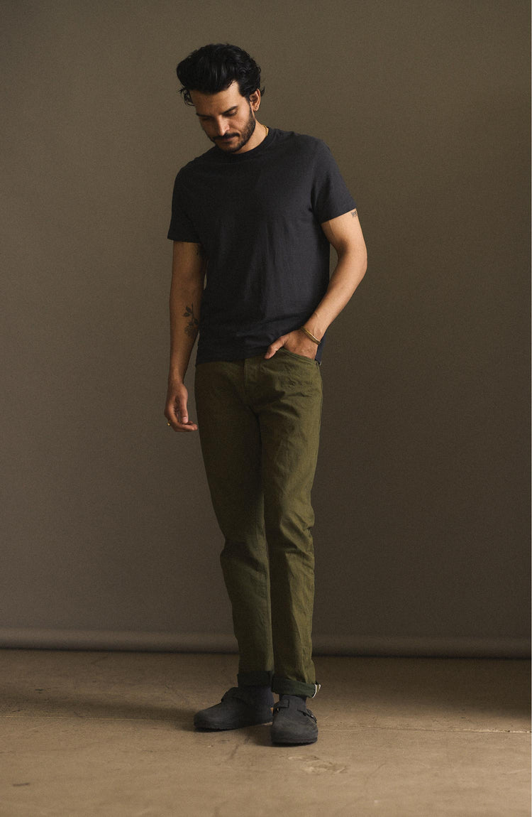 fit model posing in The Slim Jean in Olive Nihon Menpu Selvage