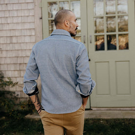 fit model sitting wearing The Division Shirt in Washed Indigo