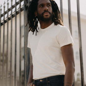 fit model leaning against the wall in The Cotton Hemp Tee in Natural