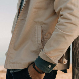 fit model showing off the pockets on The Flint Jacket in Light Khaki Broken Twill