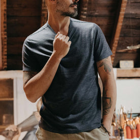 fit model adjusting the collar on The Merino Tee in Heather Navy