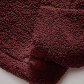 material shot of the hemmed sleeves on The Nomad Hoodie in Burgundy Sherpa