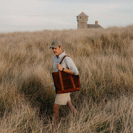 fit model walking carrying The Roughout Tote in Chocolate Suede