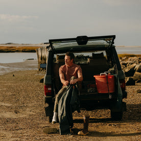 fit model sitting in a jeep in The Rugby Tee in Faded Brick