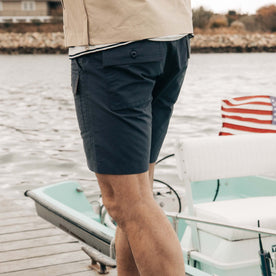 fit model walking wearing The Trail Cargo Short in Faded Navy 60/40 Faille