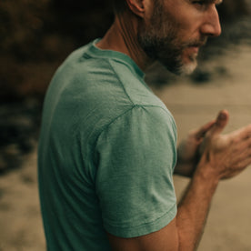 fit model walking on the beach in The Cotton Hemp Tee in Teal