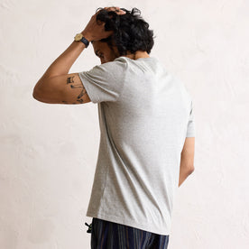 fit model showing the back of The Organic Cotton Tee in Heather Grey