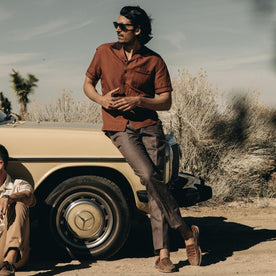 fit model leaning against a car wearing The Palmer Shirt in Dried Guajillo