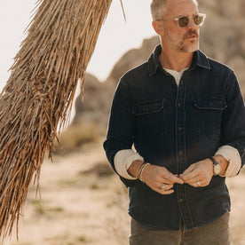 fit model standing by a tree wearing The Division Shirt in Indigo Twill