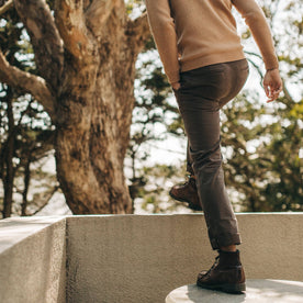 fit model wearing the foundation pant, walking up ledge