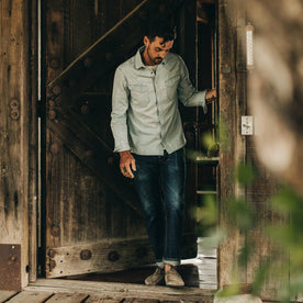 fit model wearing The Western Shirt in Washed Denim, walking through door