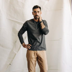 fit model posing in The Organic Cotton Henley in Faded Black
