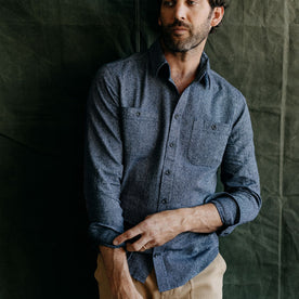 fit model adjusting his sleeves in The Utility Shirt in Rinsed Indigo Herringbone