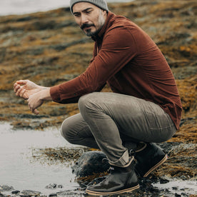 fit model sitting outdoors in The Slim All Day Pant in Morel Cord