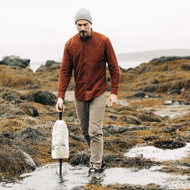 fit model walking in a marshy field in The Slim All Day Pant in Morel Cord