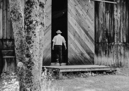 Mark Holthusen walking into a wooden barn