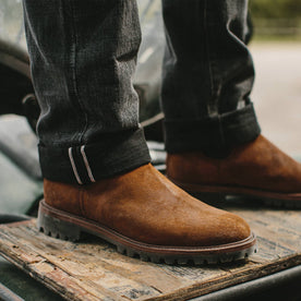 fit model wearing The Ranch Boot in Redwood Waxed Suede, looking right