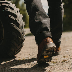 fit model wearing The Ranch Boot in Redwood Waxed Suede, walking away from camera